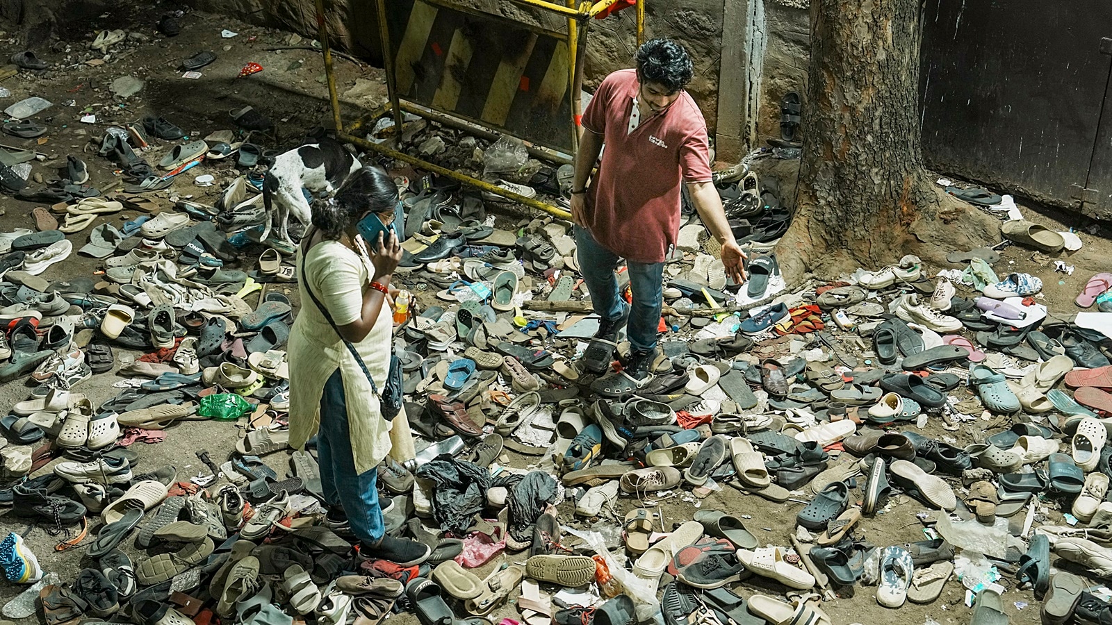 Footwears lie on the ground outside the Chinnaswamy Stadium following a stampede