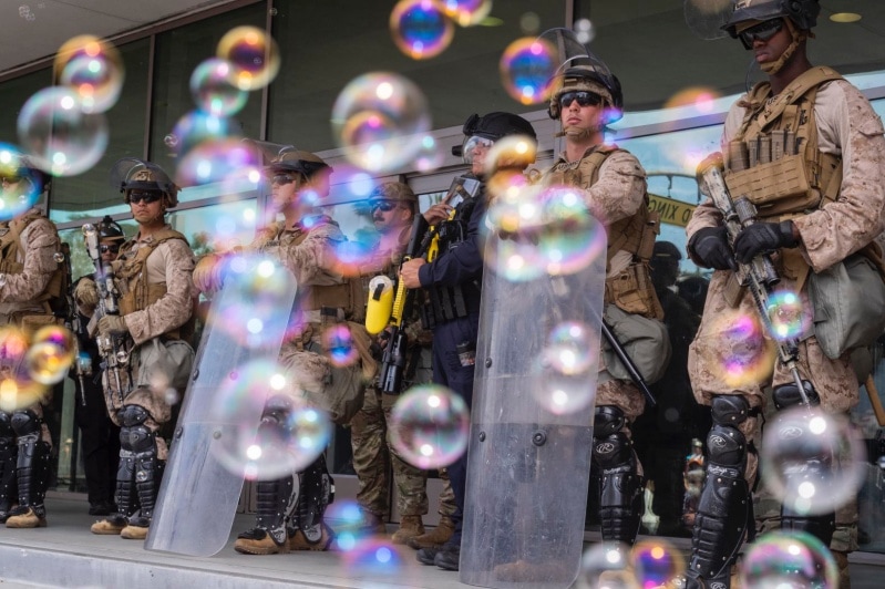 Bubbles float past US Marines stationed outside the Federal Building in Los Angeles 