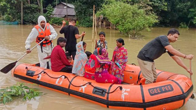 SDRF Assam personnel rescues victims from inundated areas during flood relief operation