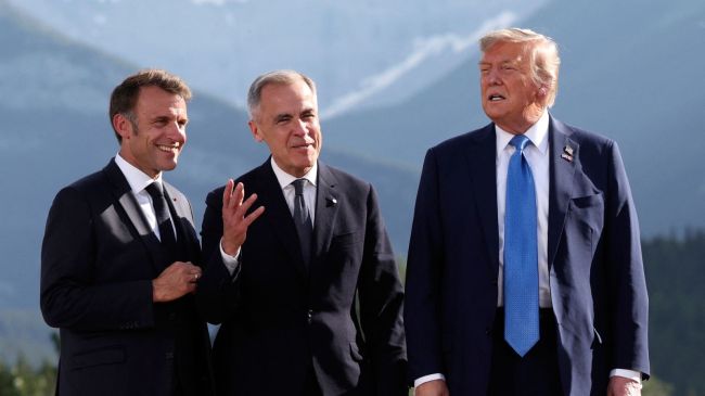 French President Emmanuel Macron, from left, Canada's Prime Minister Mark Carney and U.S. President Donald Trump attend a family photo session during the G7 Summit, in Kananaskis, Alberta, Monday, June 16, 2025