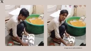 The boy is seen squatting in a cramped bathroom space, scrubbing utensils in viral video