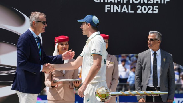 Australia's captain Pat Cummins is greeted by an official during the presentation ceremony after their loss in the World Test Championship final against South Africa at Lord's cricket ground in London, Saturday, June 14, 2025. (AP Photo)