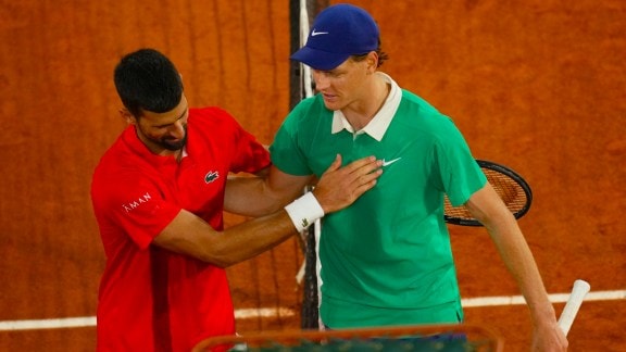Jannik Sinner, right, and Novak Djokovic greet each other after their semifinal match of the French Tennis Open at the Roland-Garros stadium in Paris on June 6, 2025. (AP Photo)