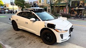 A Waymo Jaguar I-Pace robotaxi waits at the curb in San Francisco. The rooftop lidar dome houses sensors that help the vehicle "see" its surroundings. (Image: Bijin Jose/The Indian Express)
