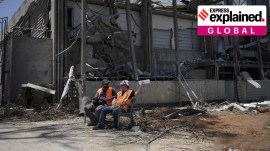 Workers sit next to a building at the Weizmann Institute of Science destroyed by an Iranian missile in Rehovot Iran-Israel: After the fighting has stopped