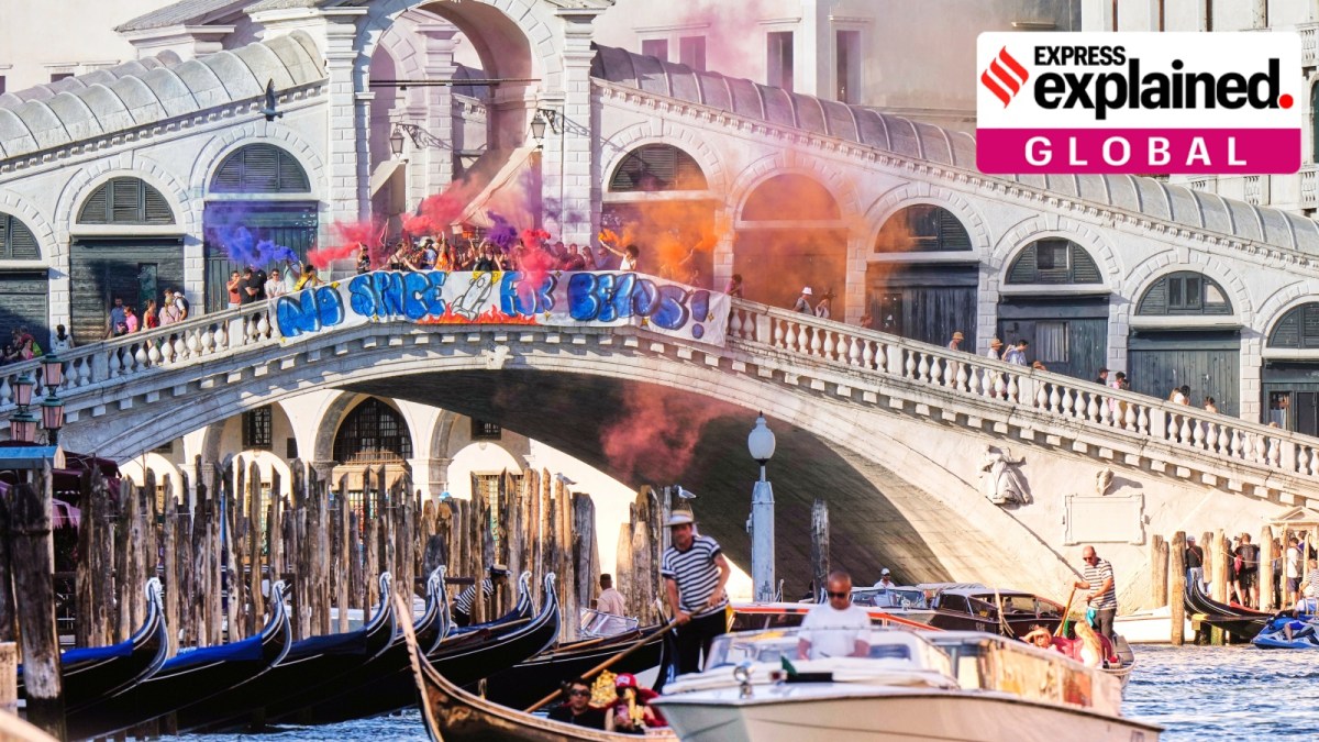 Activists stage a protest on the Rialto Bridge in Venice, Italy, Saturday, June 28, with a banner saying, "No space for Bezos". (AP Photo/Luca Bruno)