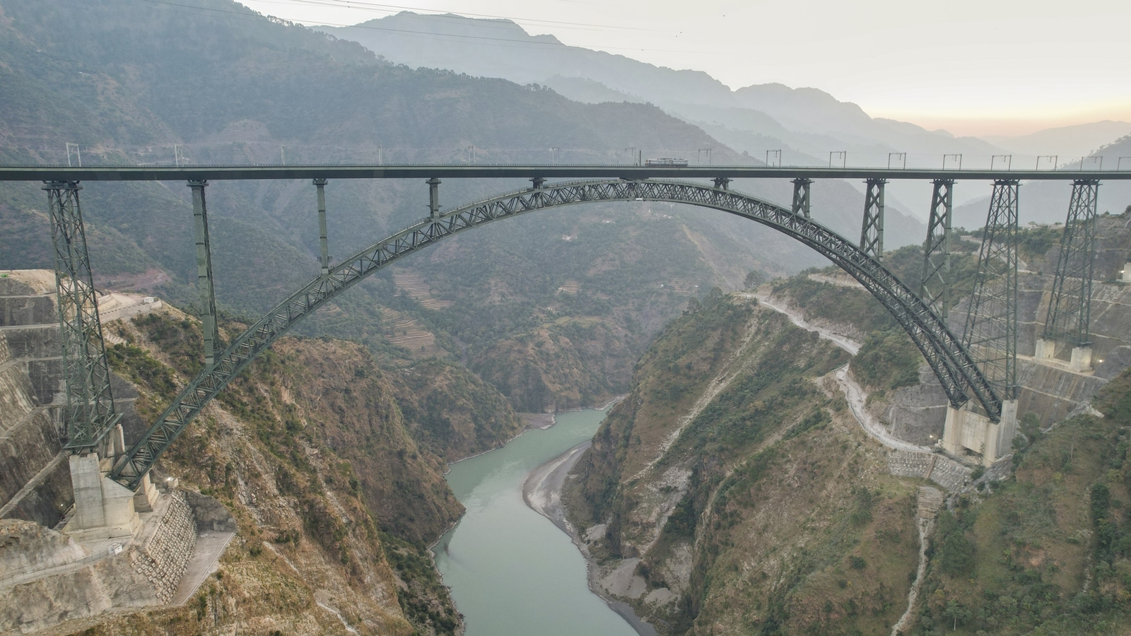 Chenab railway bridge, world's highest rail bridge, Jammu and Kashmir railway project, Vande Bharat Srinagar Katra, Chenab bridge inauguration, PM Modi Chenab bridge, Vande Bharat trains Kashmir, Chenab bridge construction, Chenab bridge challenges, Konkan Railway Chenab bridge, Chenab bridge design, High-speed rail bridge, USBRL project, Narendra Modi inauguration, Indian Railways infrastructure, Chenab River bridge height, railway connectivity Kashmir, tallest railway arch bridge, Express Explained