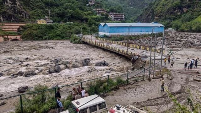 People stand near a damaged area at Sainj valley amid flash floods following cloudbursts, in Kullu district, Himachal Pradesh, Wednesday, June 25, 2025. (PTI Photo)