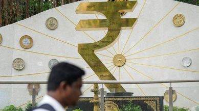 A man walks past an installation at the Reserve Bank of India (RBI) headquarters, in Mumbai, Friday, June 6, 2025. (PTI Photo)