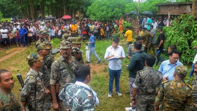 Forest officials at the site after an adult Royal Bengal Tiger entered a farmer's house, at a village in Ranchi district of Jharkhand
