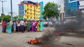 BJD workers take part in a demonstration during a bandh called by the party in protest against the death of a college student, in Balasore, Odisha
