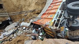 Workers removing the bottles from the truck on the Southern Peripheral Road in Gurgaon, Friday. Abhimnayu Hazarika