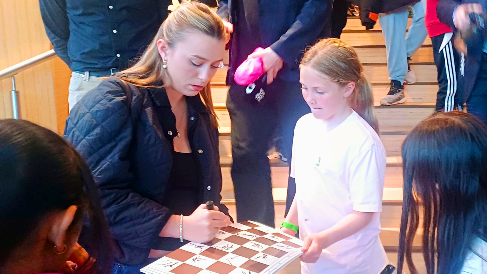 Ella Carlsen, Magnus Carlsen's wife, gives autographs to young fans after the Norway Chess tournament. (Express Photo by Amit Kamath)