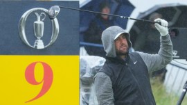 Scottie Scheffler of the United States walks onto the 8th green in heavy rain during a practice round for the British Open golf championship at the Royal Portrush Golf Club, Northern Ireland, Tuesday, July 15, 2025. (AP Photo)