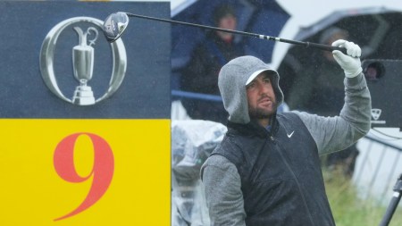 Scottie Scheffler of the United States walks onto the 8th green in heavy rain during a practice round for the British Open golf championship at the Royal Portrush Golf Club, Northern Ireland, Tuesday, July 15, 2025. (AP Photo)