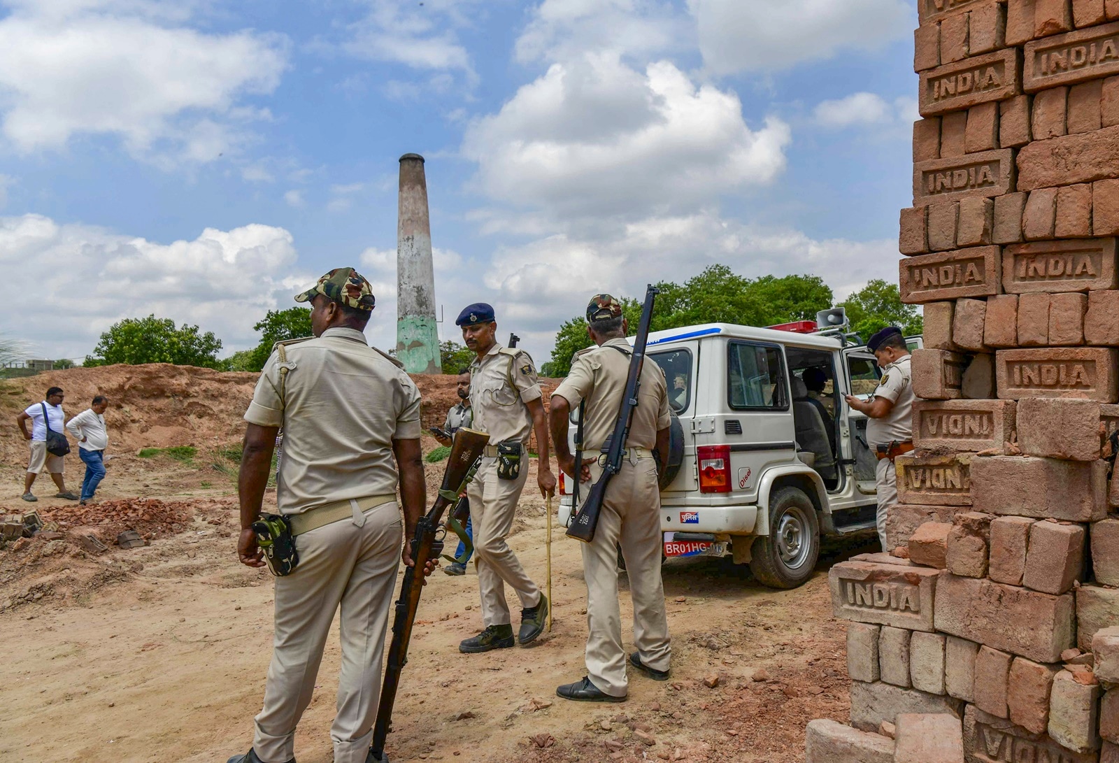 Police personnel stand guard at the site after a key suspect in the murder of industrialist Gopal Khemka was killed in a gunfight, in Patna's Damaria Ghat area on Tuesday