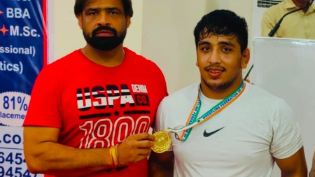 Hardeep with his coach and Arjuna Award winning wrestler Dharmender Dalal. (Special arrangement)