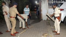 Police personnel during an investigation at an area after businessman Gopal Khemka was allegedly shot dead when he was returning home. (PTI Photo)