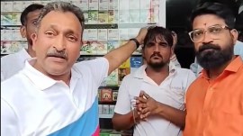 MNS workers with the shopkeeper in Mumbai’s Vikhroli area. (Screengrab: Facebook)