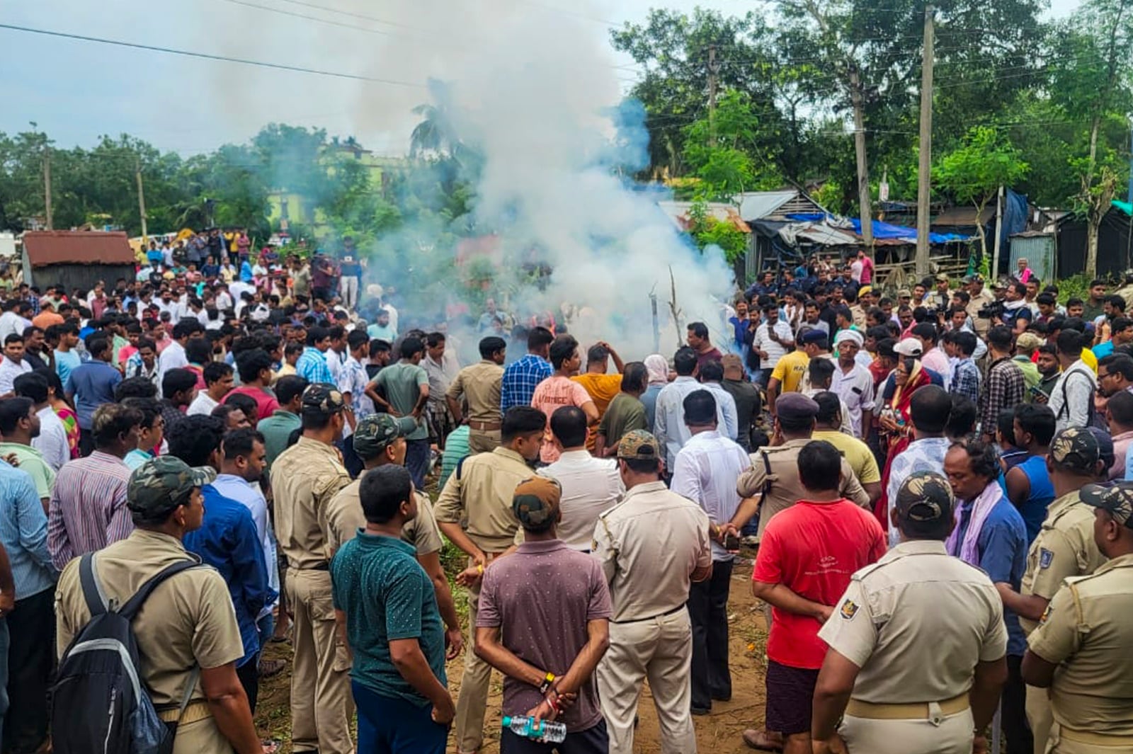 Police personnel stand guard as mortal remains of the college student, who set herself ablaze, was cremated