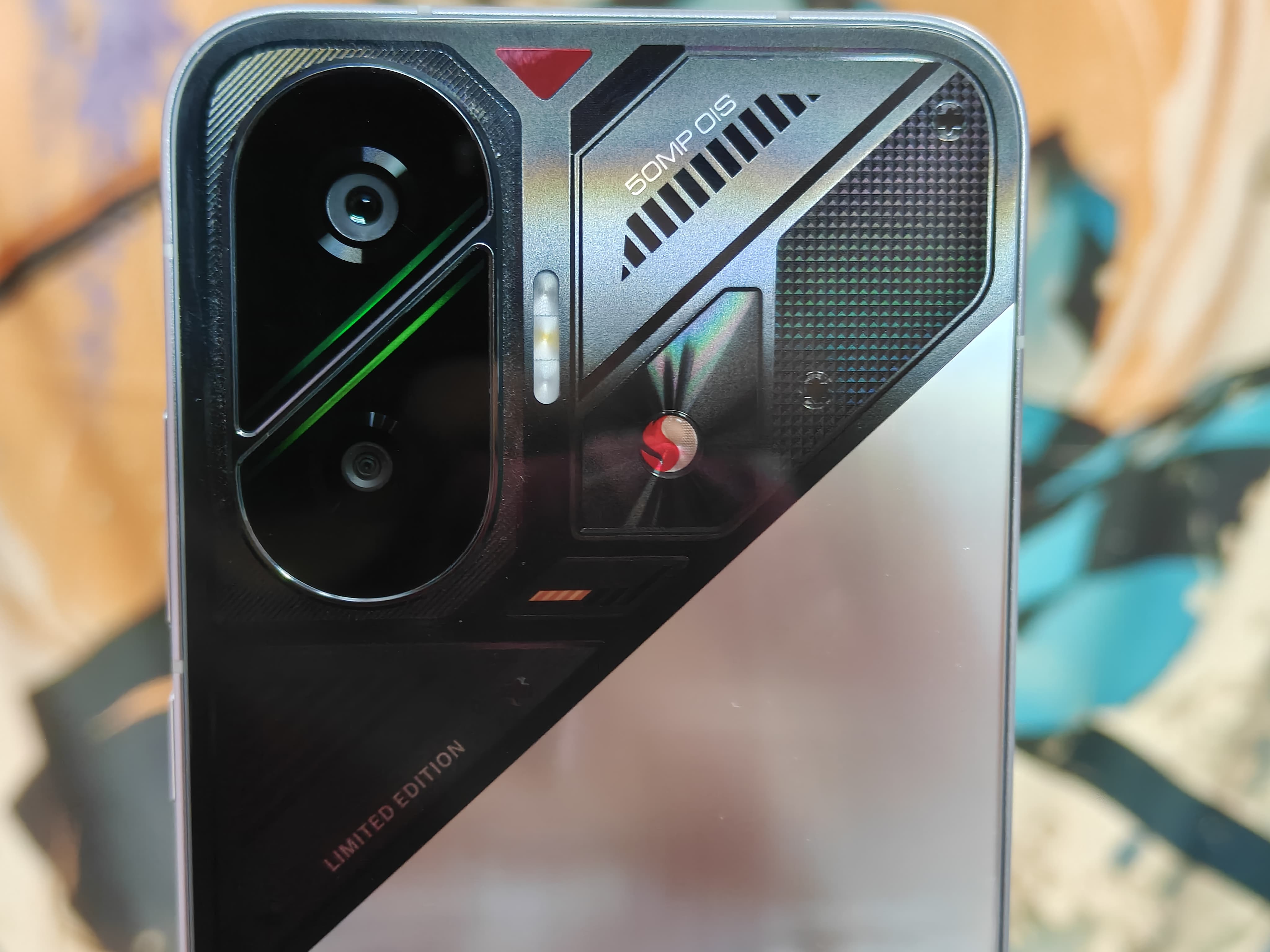 The cameras are physically separated by a divider with green accents around it.