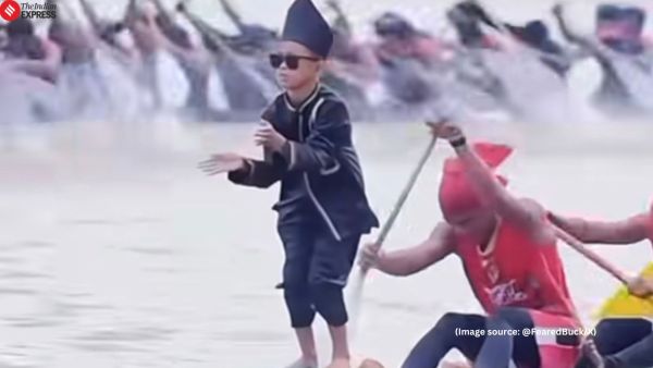 Positioned at the prow of the moving race boat rowed by at least several adults, he blew kisses to both sides and waved his arms (Image source: @FearedBuck/X)