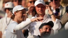 Italy's Jannik Sinner greets his team in the players box as he celebrates after beating Carlos Alcaraz of Spain to win the men's singles final at the Wimbledon Tennis Championships in London. (AP)