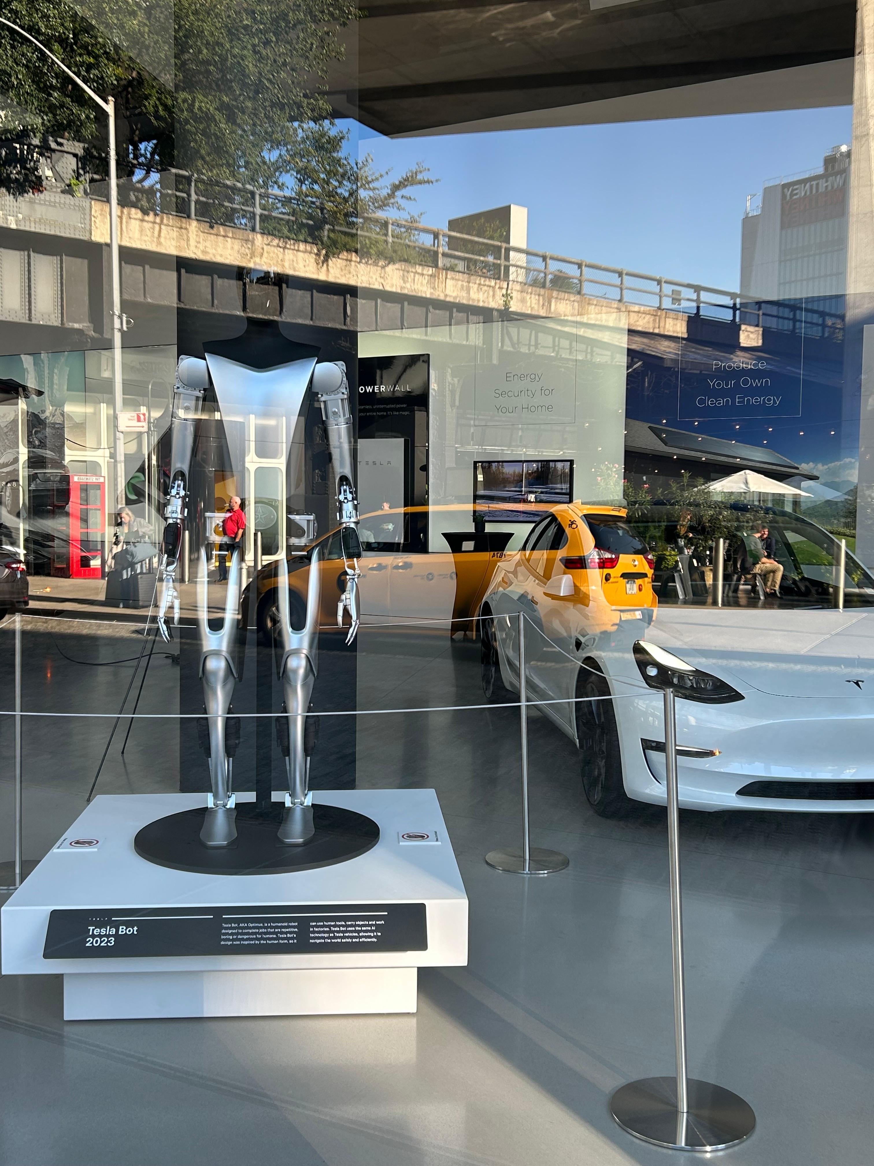 Tesla showroom in the US with the roadster and Optimus humanoid robot on display. 