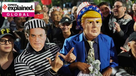 Protesters wearing masks of U.S. President Donald Trump, right, and former President of Brazil Jair Bolsonaro demonstrate after Trump's announcement of 50% tariffs on Brazilian goods, in Sao Paulo Thursday, July 10, 2025.
