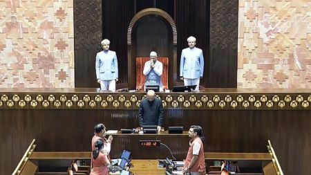 Rajya Sabha Deputy Chairman Harivansh Narayan Singh greets members of the House during the Monsoon session of Parliament, in New Delhi, Tuesday, July 22, 2025.