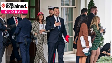 Jack Posobiec, a far-right political activist, leaves an entrance of the West Wing with a red hat and a binder on Jeffrey Epstein at the White House in Washington, Feb. 27, 2025.