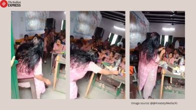 government school teacher oiling hair during class