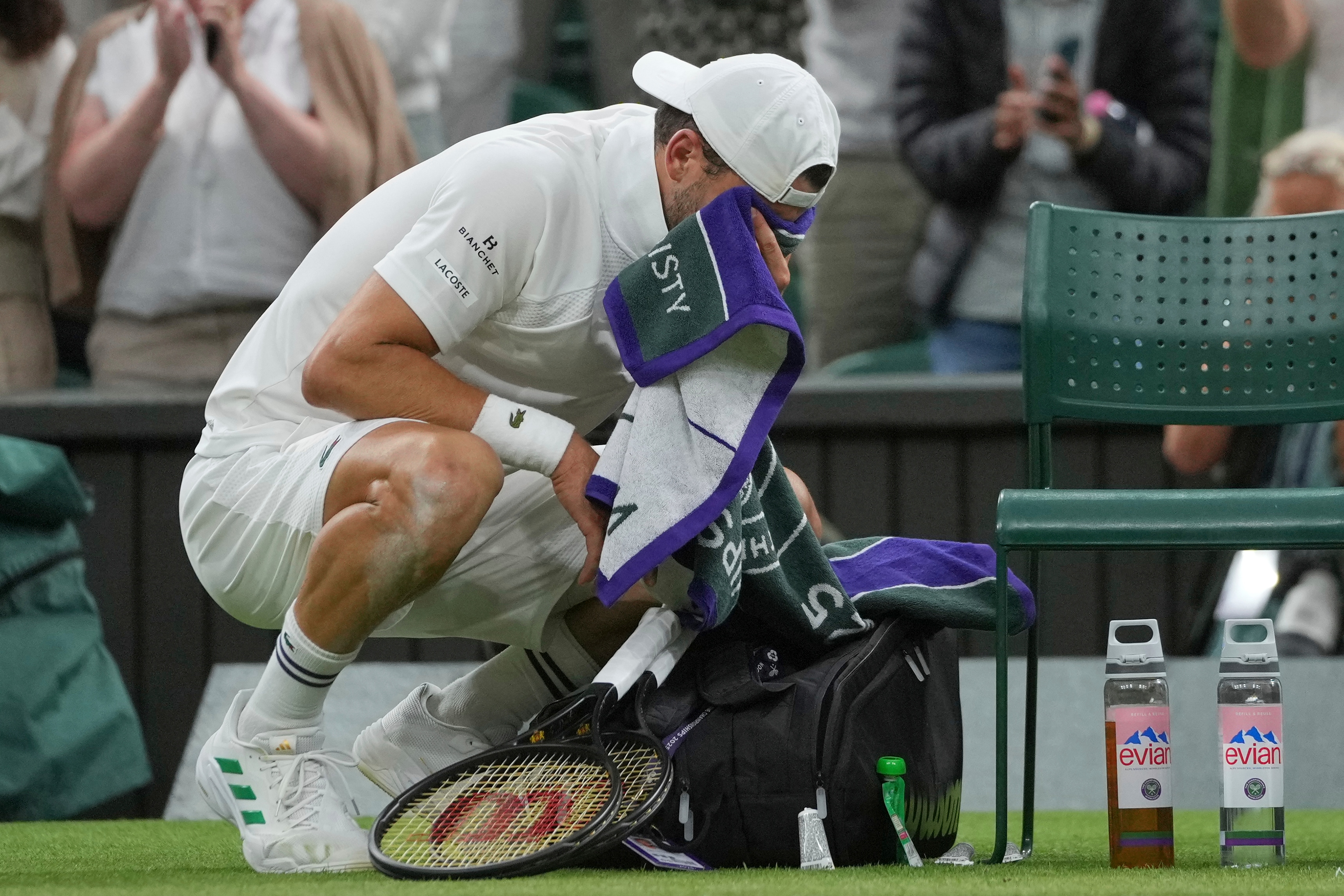 Bulgaria's Grigor Dimitrov reacts after he was forced to retire with a chest injury from a fourth round men's singles match against Italy's Jannik Sinner at the Wimbledon Tennis Championships in London, Monday, July 7, 2025. (AP Photo/Kin Cheung)