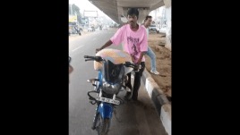 Accused with the sack loaded on bike