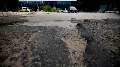 Traffic snarls due to 'poor' road condition: BJP leaders sit on pothole-ridden highway stretch to mark their protest | Ahmedabad News - The Indian Express