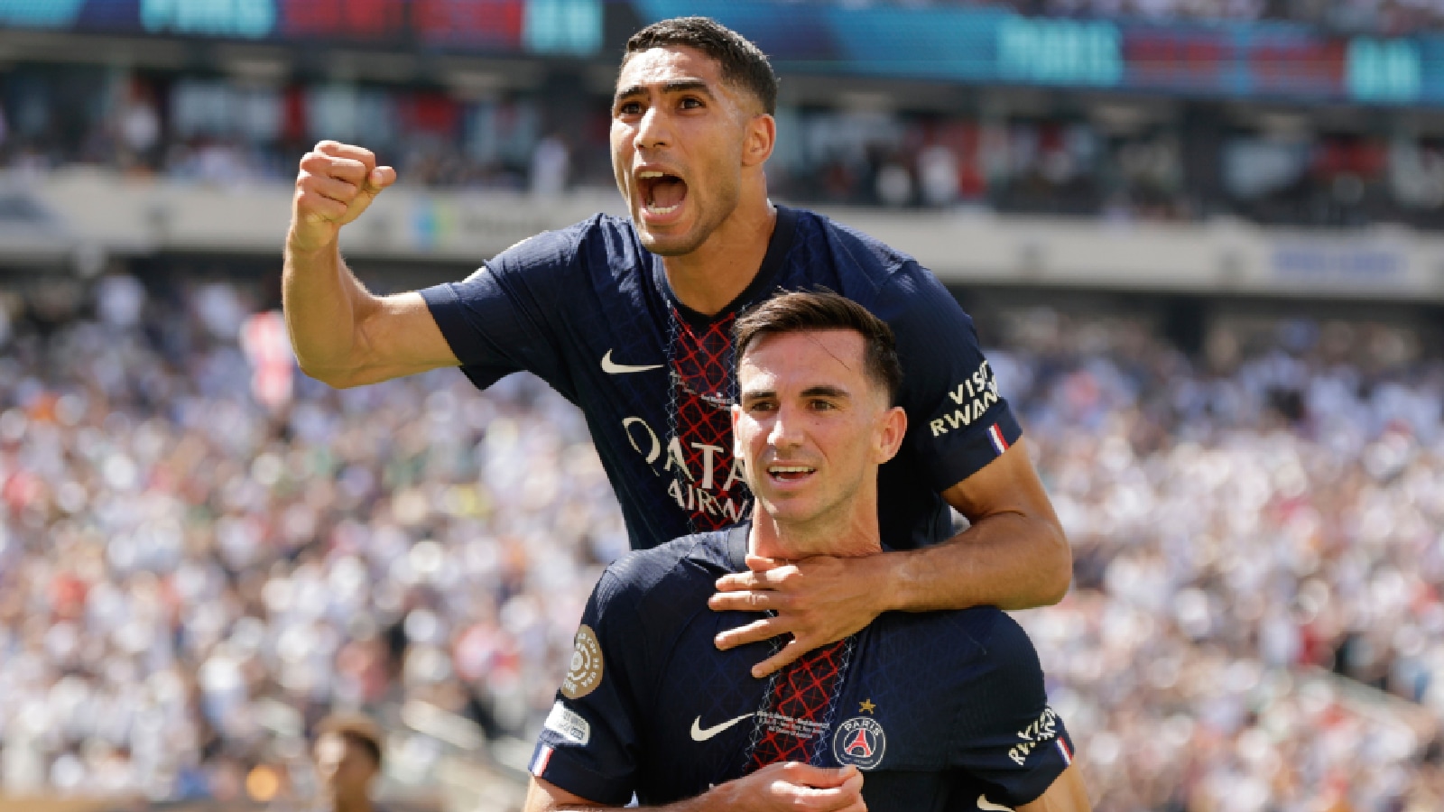 Paris Saint-Germain's Fabian Ruiz, bottom, celebrates with team mate Achraf Hakimi after scoring his side's third goal during the Club World Cup semifinal soccer match between PSG and Real Madrid in East Rutherford, N.J., Wednesday, July 9, 2025. (AP Photo)