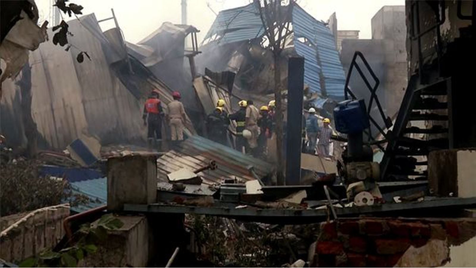 tate Disaster Response Force (SDRF) and Fire Service Department personnel conduct a search and rescue operation after a reactor blast took place triggering a massive fire at Sigachi Pharma Company, leaving 12 killed and several others injured, in Sangareddy on Monday. (ANI Video Grab)