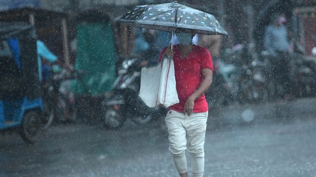 Pedestrians during rainfall in Tripura