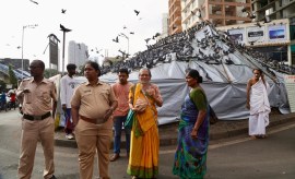 Feeding pigeons in Mumbai is now banned, with fines for violators, and in light of the HC directives, the civic body on Saturday evening installed bamboo poles and covered out plastic sheets over the Dadar feeding ground to enforce the ban. (Express Photo/Akash Patil)