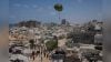 Palestinians rush to collect humanitarian aid airdropped by parachutes into Gaza City, northern Gaza Strip. (AP/PTI)