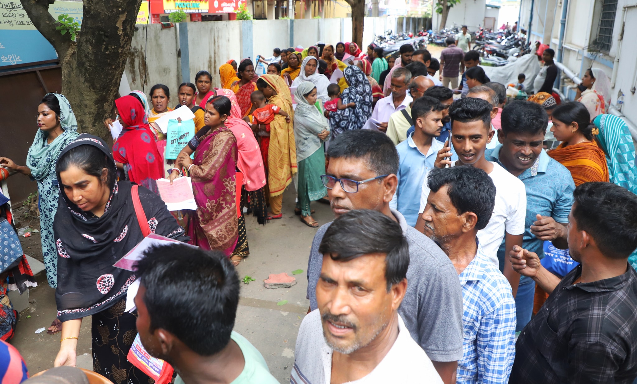 People waiting in queue at the Baharampur municipality office. (Express photo by Chayan Majumdar)