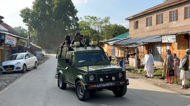 Security personnel keep a vigil amid an ongoing encounter between security forces and terrorists in a forest area at Akhal, in Kulgam district on Sunday