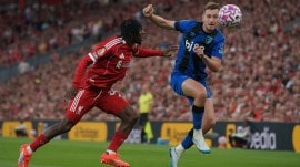 Liverpool's Jeremie Frimpong, left, and Bournemouth's David Brooks vie for the ball during the English Premier League soccer match between Liverpool and Bournemouth at Anfield stadium in Liverpool, England, Friday, Aug. 15, 2025. (AP Photo/Ian Hodgson)