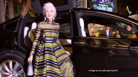 In the AI video, Maye Musk can be seen getting out of a car in a stunning multi-coloured striped gown (Image source: @mayemusk/X)