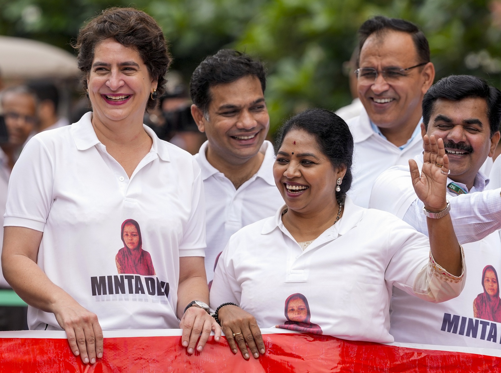 Congress MPs Priyanka Gandhi Vadra and R. Sudha seen wearing T-shirts featuring the name Minta Devi during a protest alleging poll fraud in the country