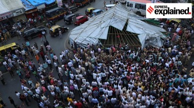 People clash with police as they tear down tarpaulin sheets put up at the Dadar Kabutarkhana.