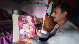 Netr Singh showing his marriage album. (Express Photo)