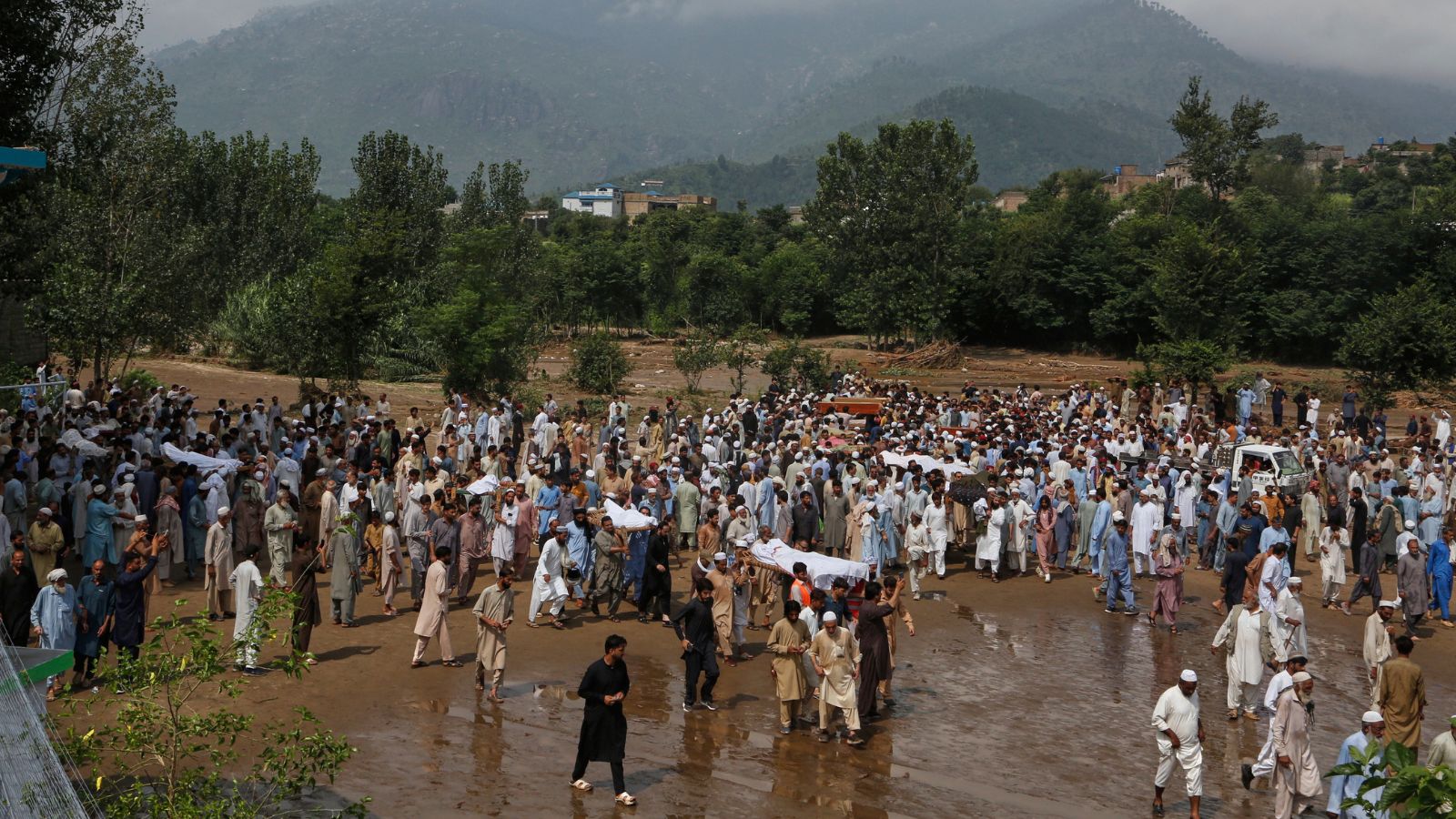 People carry bodies of the victims of Friday's flash flooding, after funeral prayers at a village near Pir Baba, Buner district, in Pakistan's northwest, Saturday, Aug.16, 2025. (AP Photo/Muhammad Sajjad)