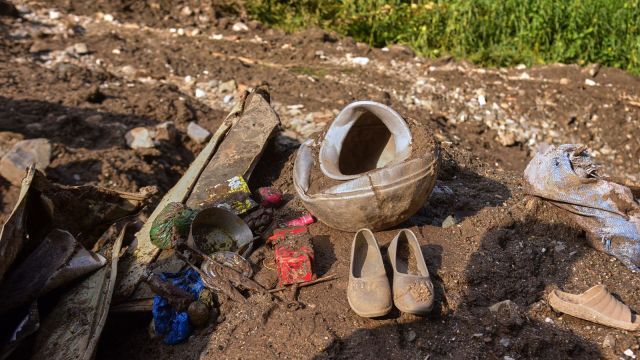 Shoes and other household items are seen on the debris of damaged houses at the incident site of cloudburst that triggered flash flood, in Naryan Behak village near Muzaffarabad, the main town of Pakistan's controlled Kashmir, Friday, Aug. 15, 2025. (AP Photo/M.D. Mughal)