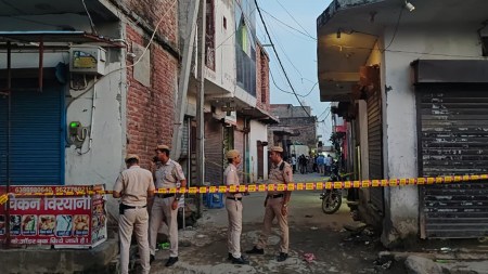 Man on the run after parents and brother found with their throats slit